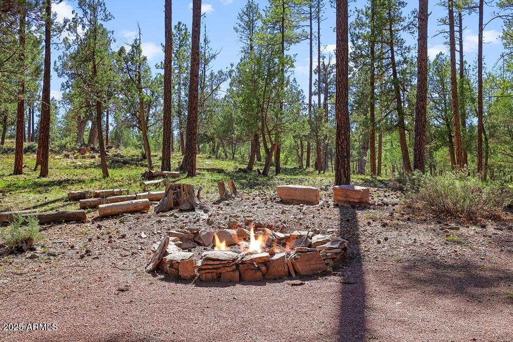 287 South Lookout Trail Payson, AZ 85541 - Photo 24 of 32 a view of a backyard with lawn chairs and a fire pit