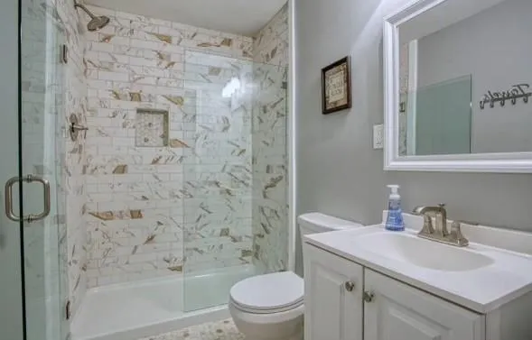 a bathroom with a sink toilet and shower