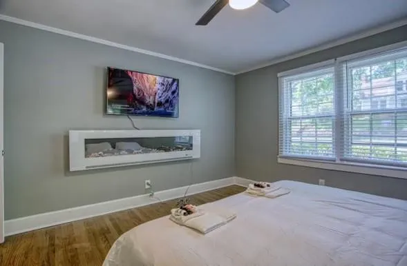 a bedroom with a bed and a flat screen tv