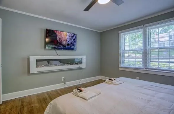a bedroom with a bed and a flat screen tv