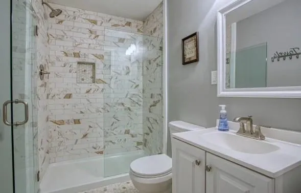 a bathroom with a sink toilet and shower