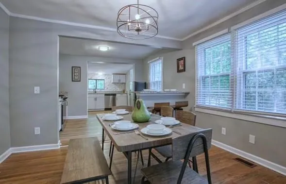 a view of a dining room with furniture window and wooden floor