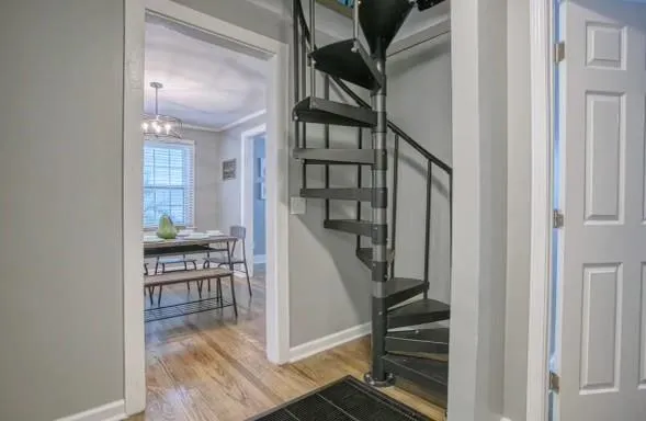 a view of entryway and hall with wooden floor