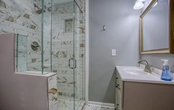 a bathroom with a sink mirror and shower