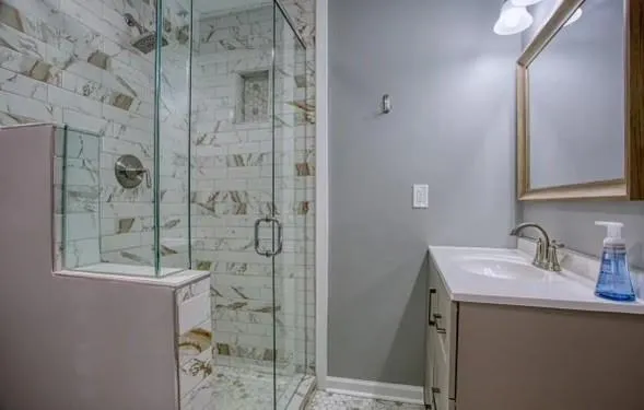 a bathroom with a sink mirror and shower