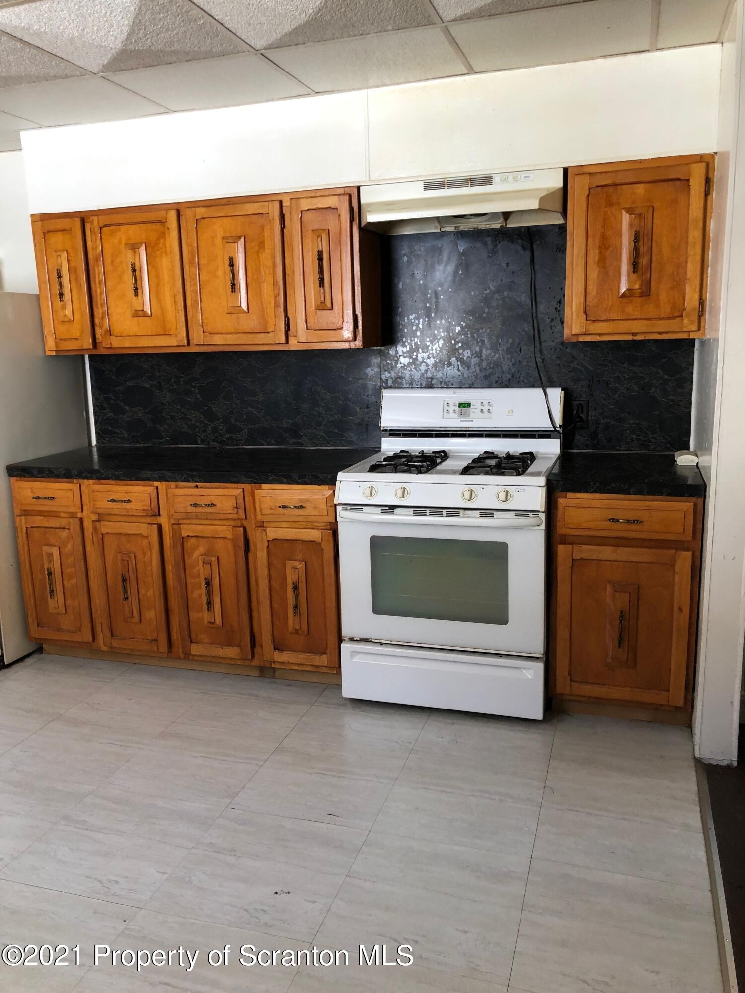 42 Fallbrook Street Carbondale, PA 18407 - Photo 19 of 41 a kitchen with stainless steel appliances granite countertop a stove a sink and a microwave