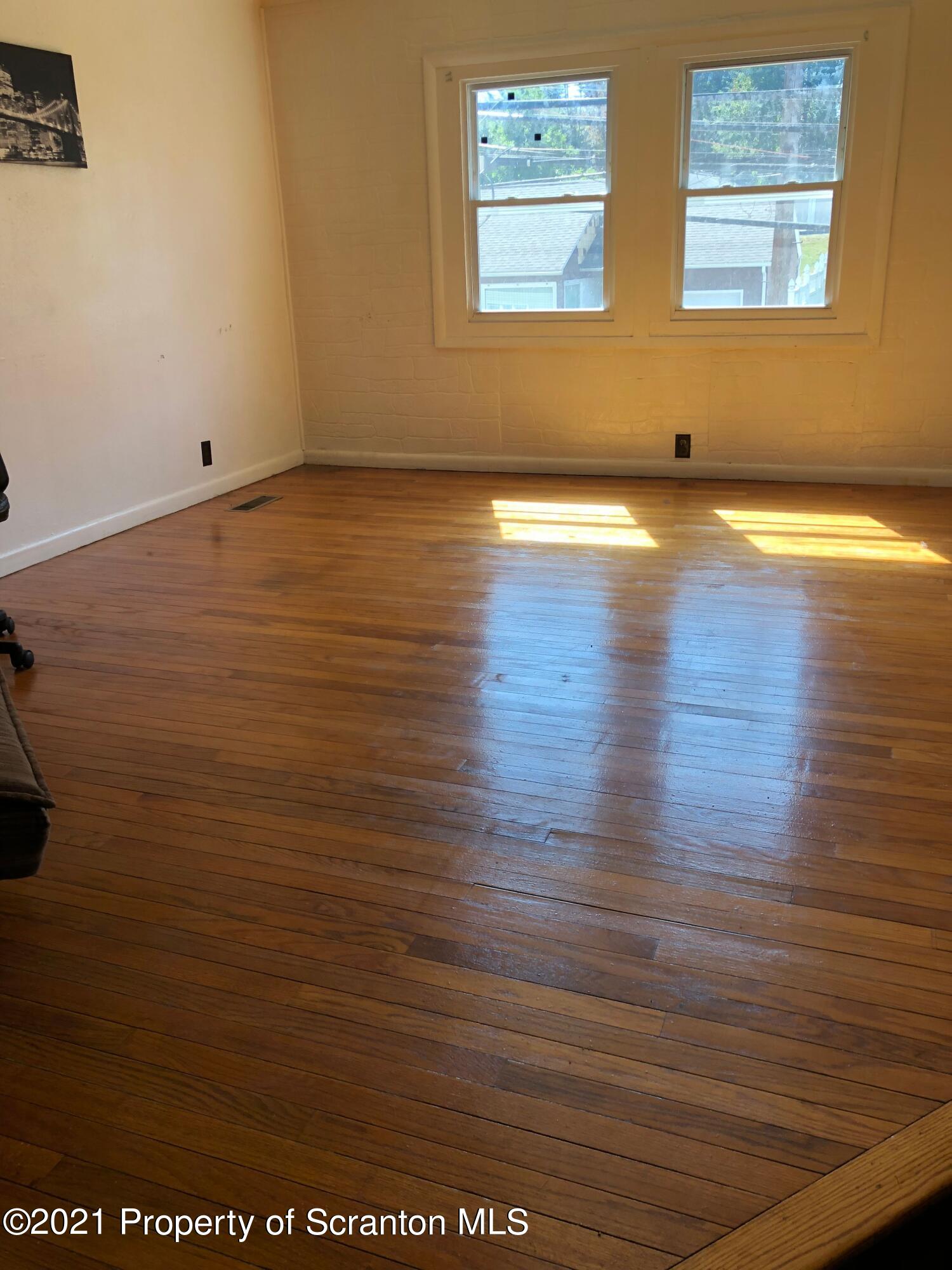 42 Fallbrook Street Carbondale, PA 18407 - Photo 20 of 41 an empty room with wooden floor and windows