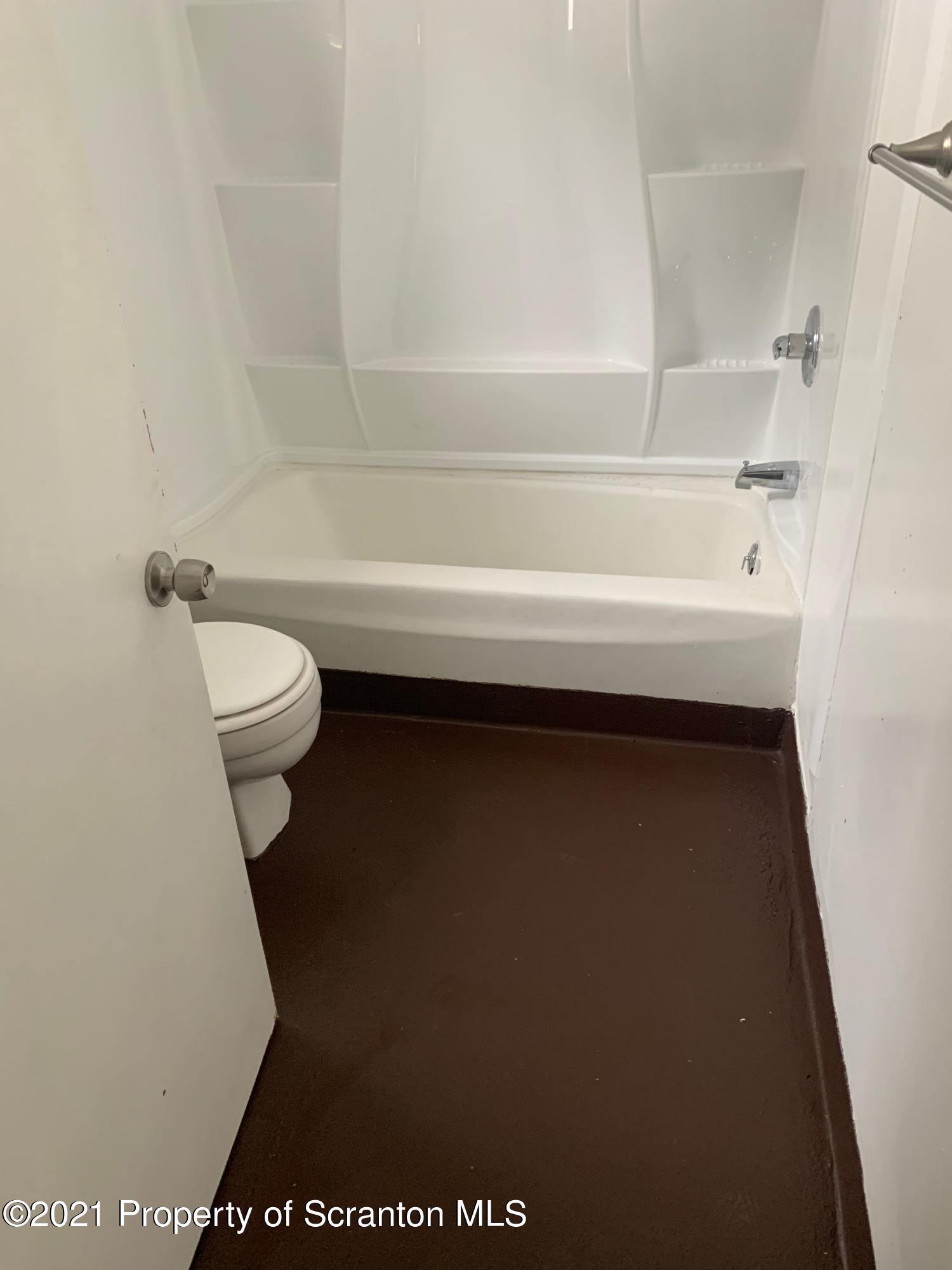 42 Fallbrook Street Carbondale, PA 18407 - Photo 27 of 41 a bathroom with a toilet and a bathtub