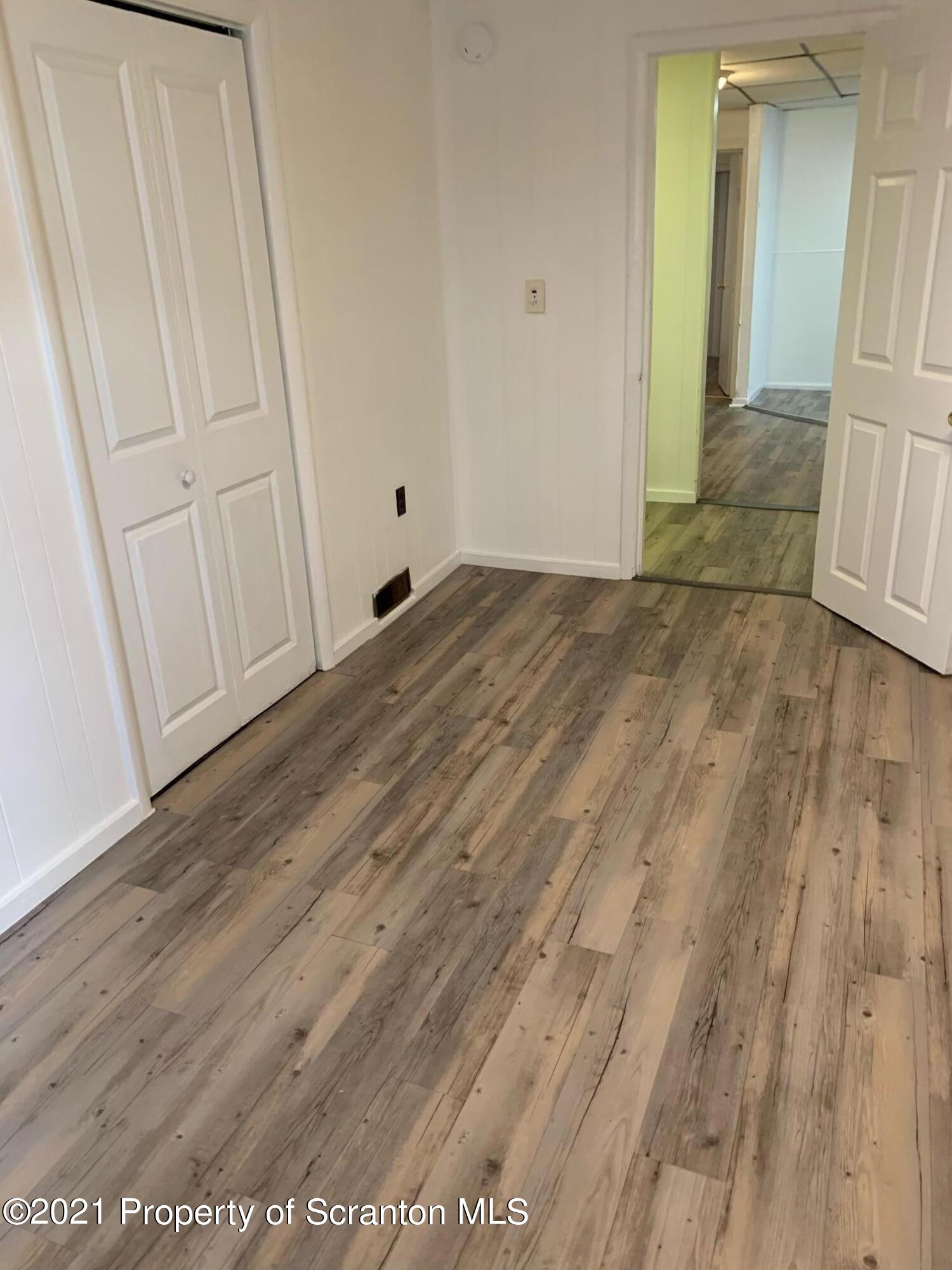 42 Fallbrook Street Carbondale, PA 18407 - Photo 38 of 41 a view of empty room with wooden floor
