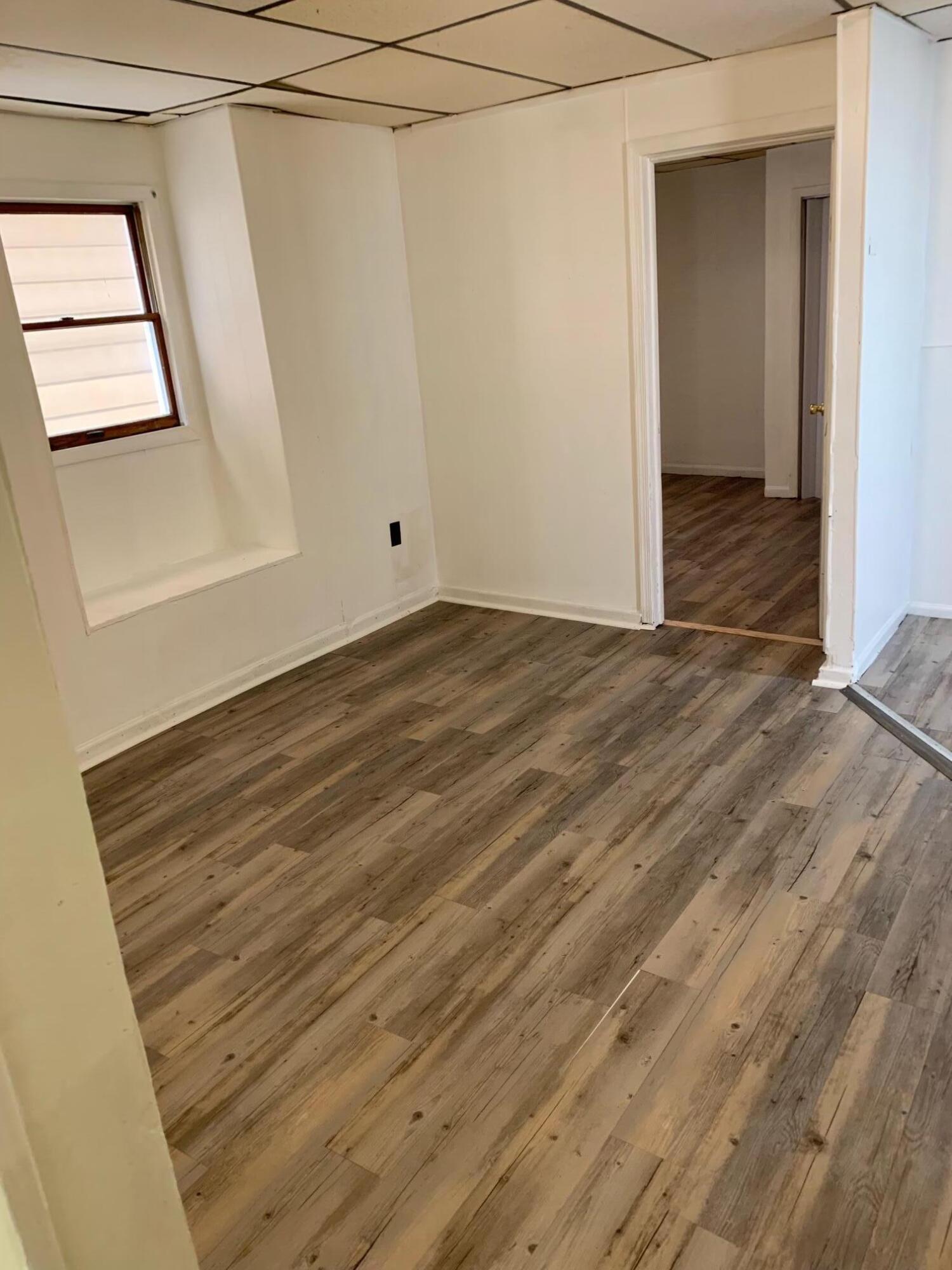 42 Fallbrook Street Carbondale, PA 18407 - Photo 40 of 41 a view of an empty room with wooden floor and a window