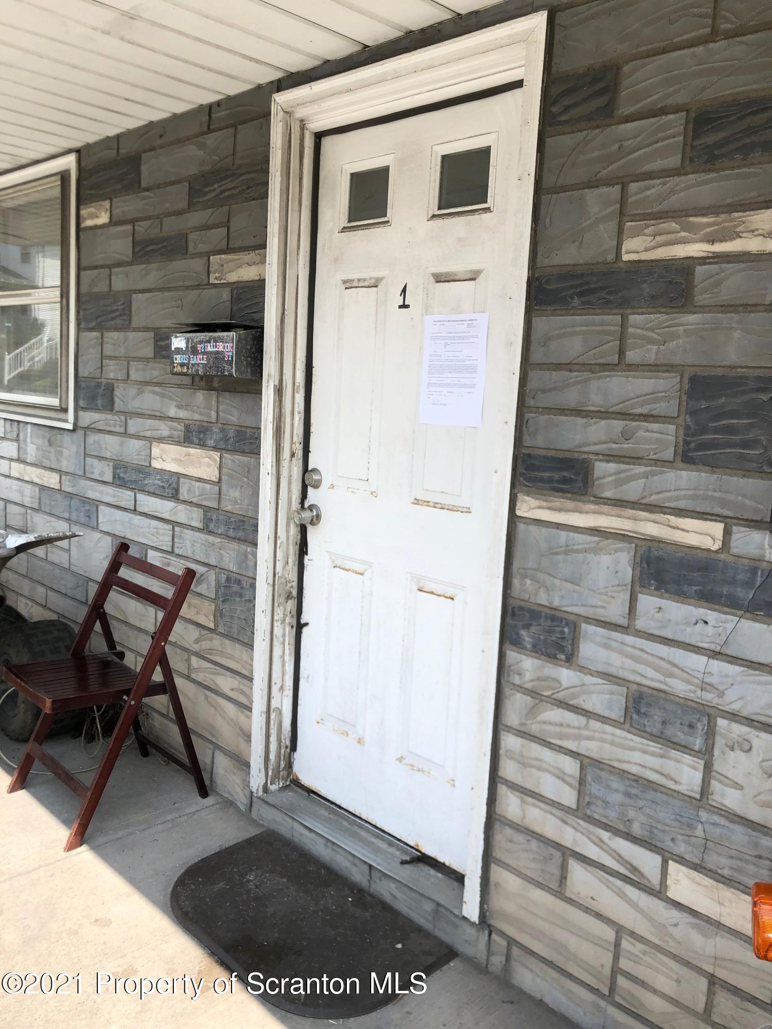 42 Fallbrook Street Carbondale, PA 18407 - Photo 5 of 41 a backyard of a house with wooden table and chairs