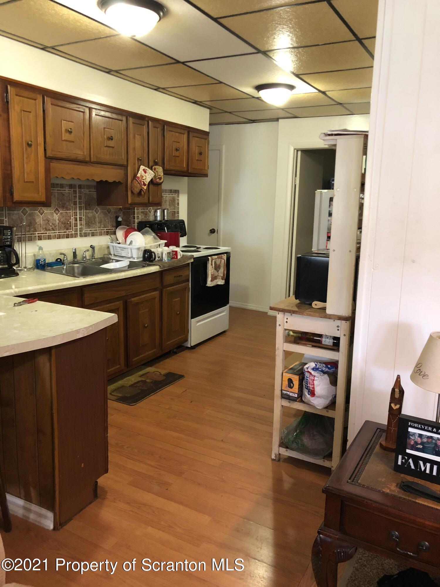 42 Fallbrook Street Carbondale, PA 18407 - Photo 6 of 41 a kitchen with stainless steel appliances a stove a sink and a microwave