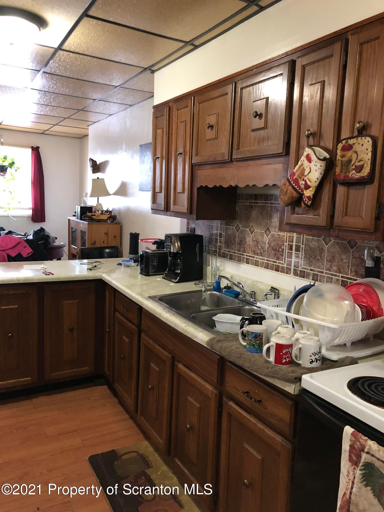 42 Fallbrook Street Carbondale, PA 18407 - Photo 7 of 41 a kitchen with a sink a stove and cabinets