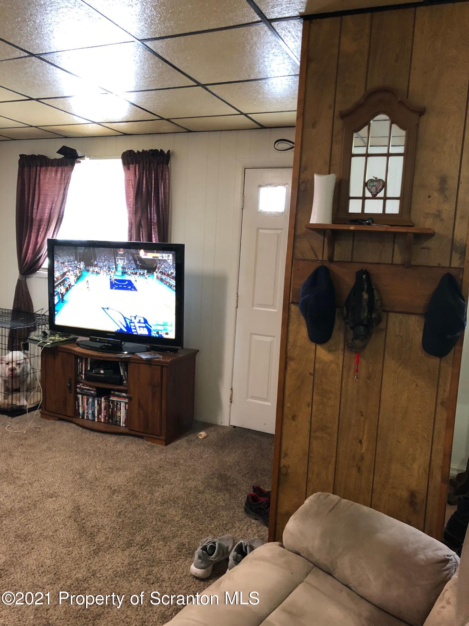 42 Fallbrook Street Carbondale, PA 18407 - Photo 8 of 41 a living room with furniture and a flat screen tv