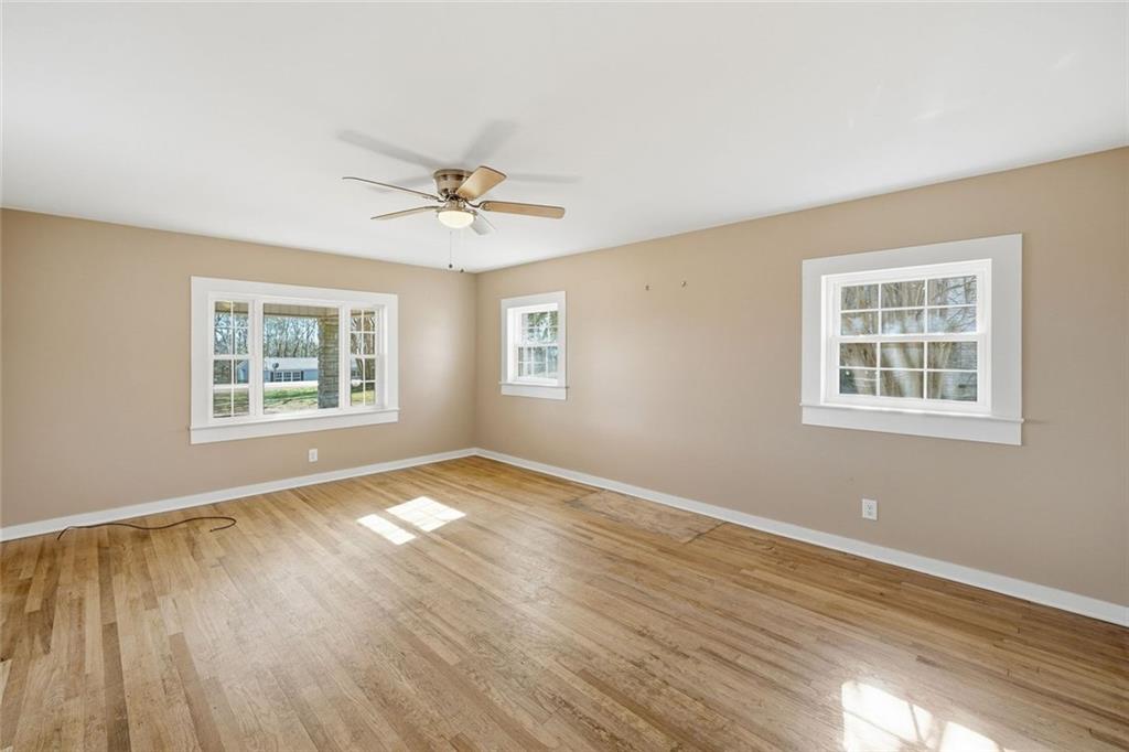 3418 Refuge Road Jasper, GA 30143 - Photo 12 of 55 a view of an empty room with a window and wooden floor