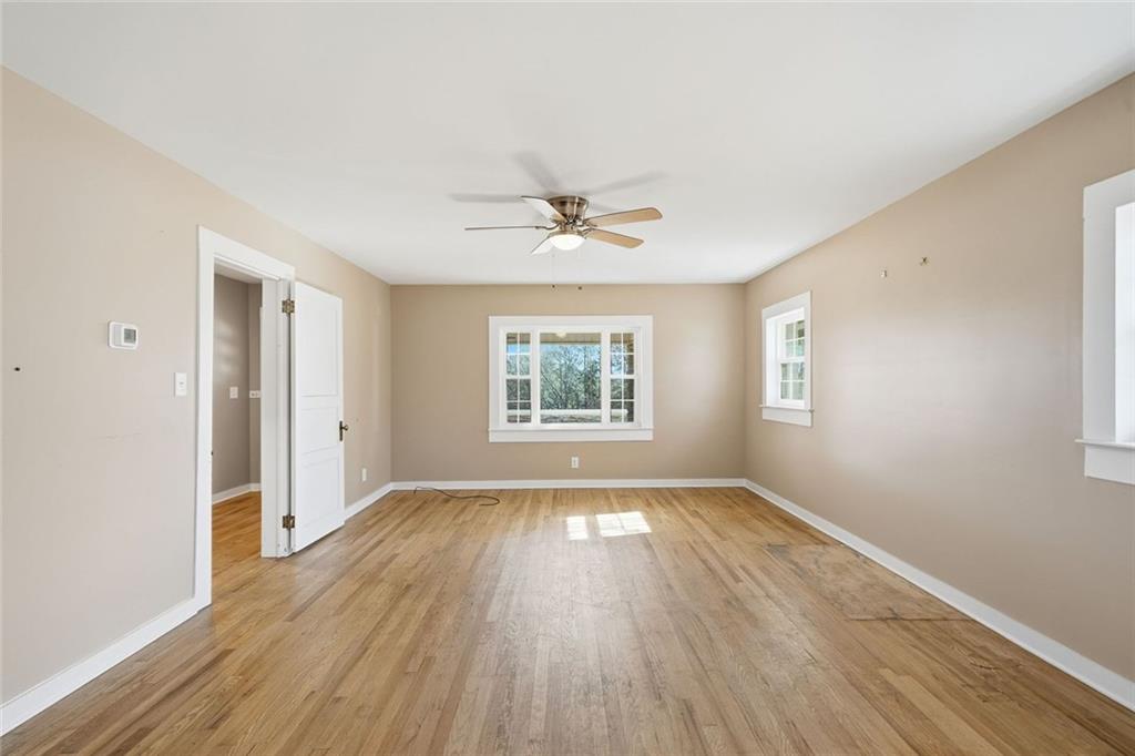 3418 Refuge Road Jasper, GA 30143 - Photo 13 of 55 a view of an empty room with wooden floor and a window