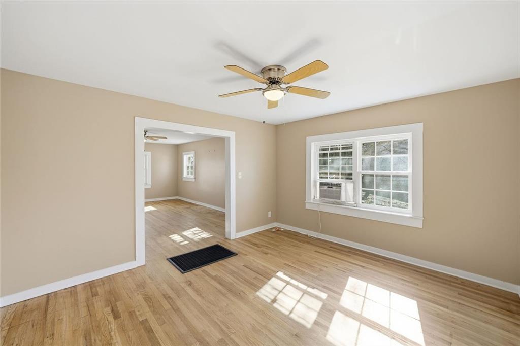 3418 Refuge Road Jasper, GA 30143 - Photo 16 of 55 a view of an empty room with a window and wooden floor