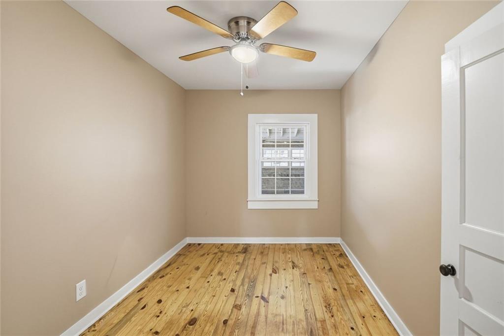 3418 Refuge Road Jasper, GA 30143 - Photo 19 of 55 a view of a room with wooden floor and a ceiling fan