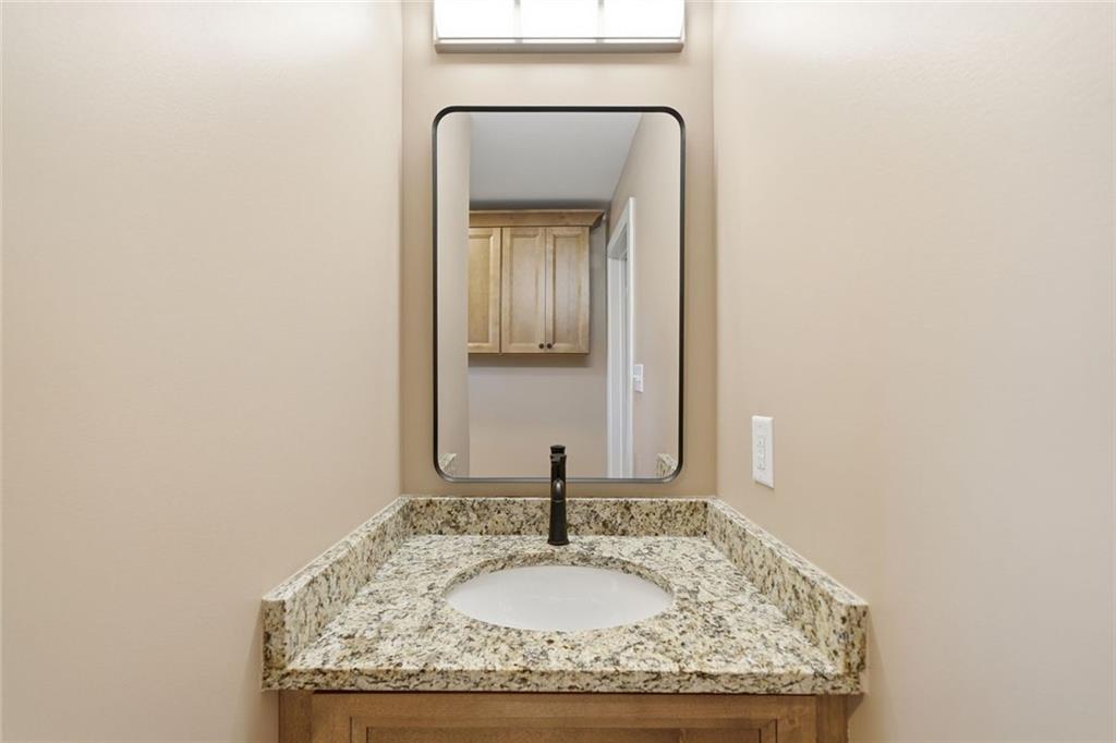3418 Refuge Road Jasper, GA 30143 - Photo 22 of 55 a bathroom with a granite countertop sink and a mirror