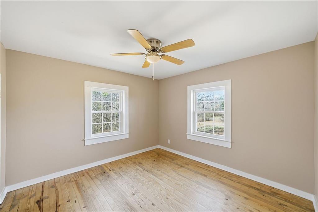 3418 Refuge Road Jasper, GA 30143 - Photo 25 of 55 a view of an empty room with a window and wooden floor