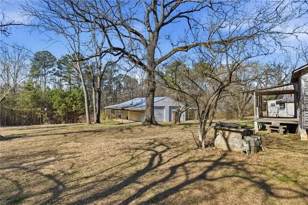 a view of a yard with large trees