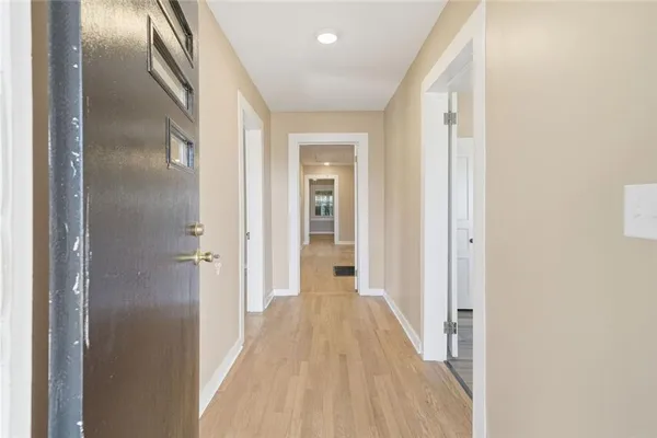 a view of a hallway with wooden floor