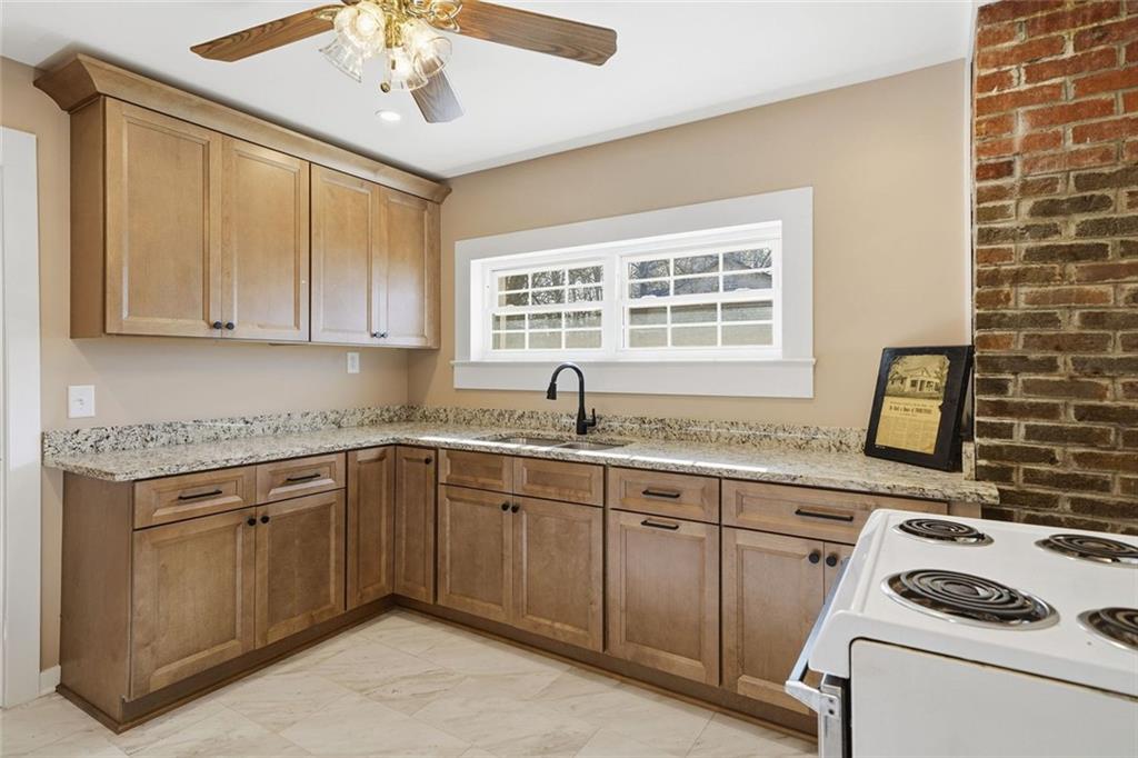 3418 Refuge Road Jasper, GA 30143 - Photo 9 of 55 a kitchen with a stove sink and cabinets