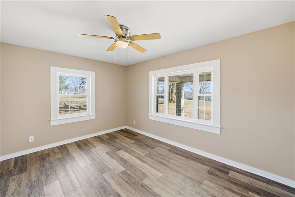 3418 Refuge Road Jasper, GA 30143 - Photo 10 of 55 a view of an empty room with wooden floor and a window