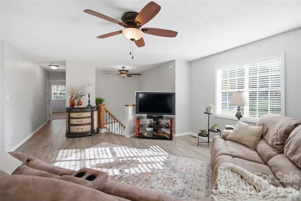 a living room with furniture a refrigerator and a fireplace