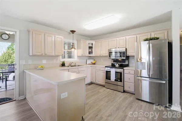 a view of living room with granite countertop furniture and a chandelier
