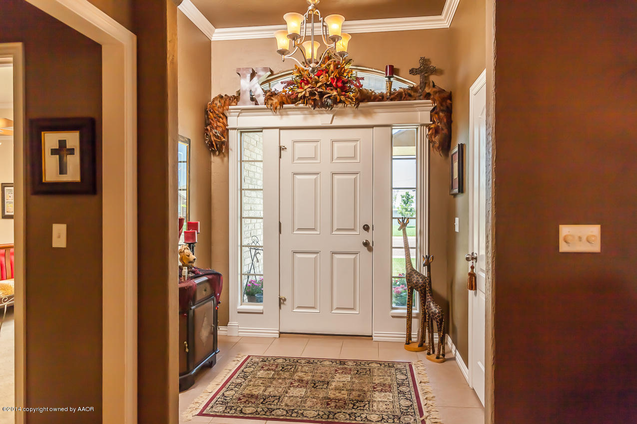 5811 South Rusk Street Amarillo, TX 79118 - Photo 2 of 22 a view of a hallway with a dining table and chairs