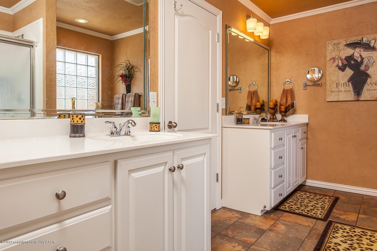 5811 South Rusk Street Amarillo, TX 79118 - Photo 12 of 22 a spacious bathroom with a double vanity sink a mirror and a bathtub