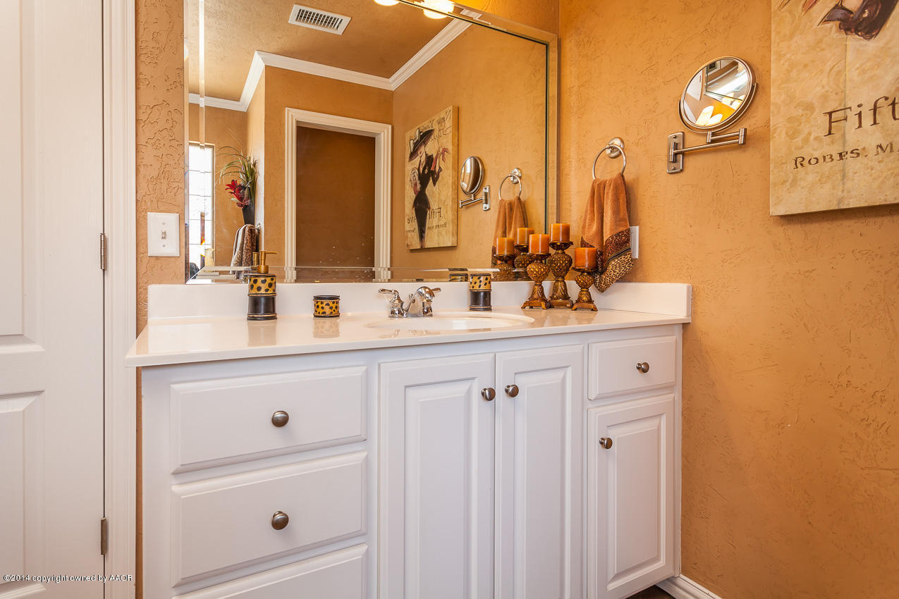 5811 South Rusk Street Amarillo, TX 79118 - Photo 14 of 22 a bathroom with a sink and a mirror
