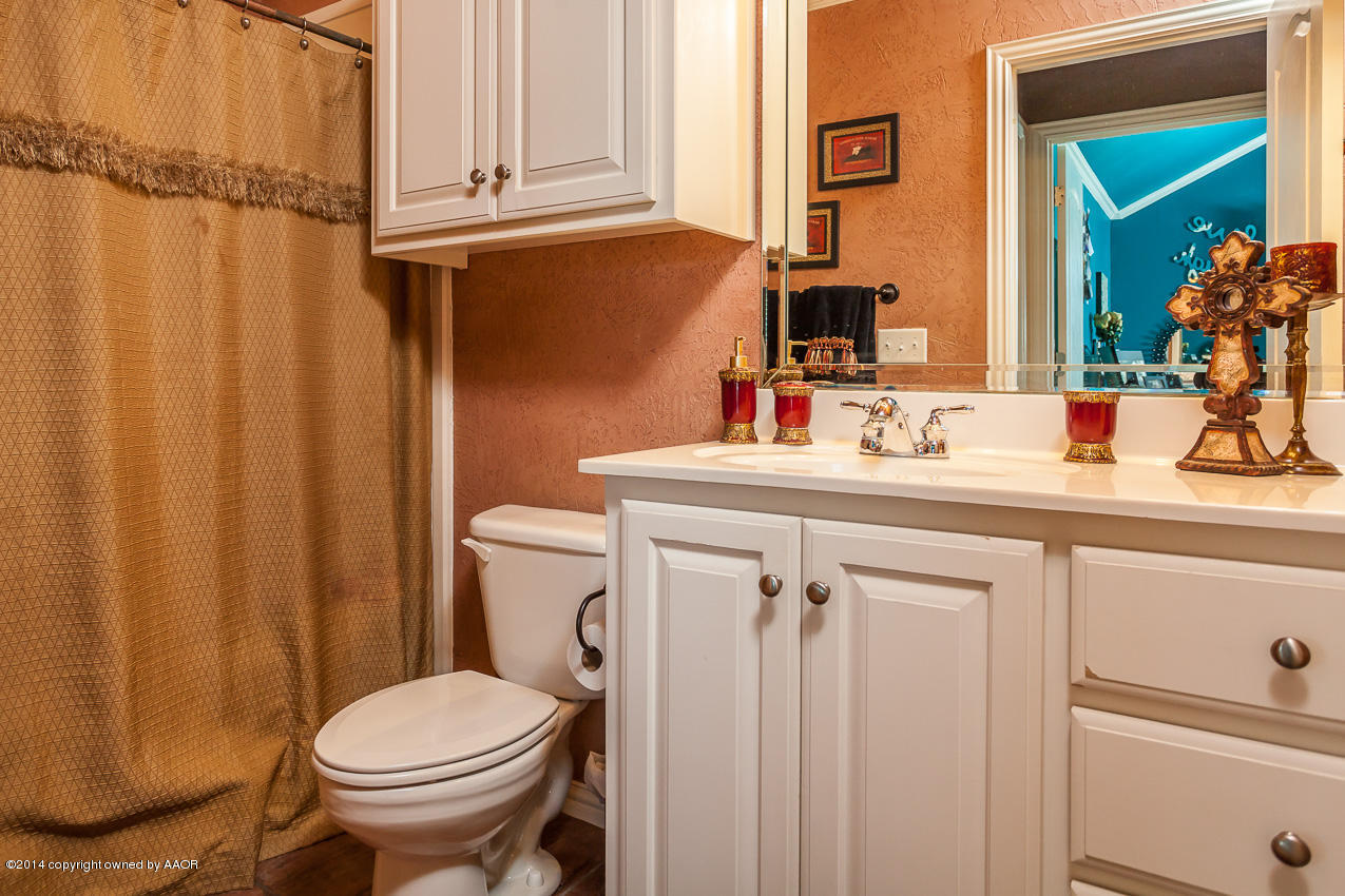5811 South Rusk Street Amarillo, TX 79118 - Photo 16 of 22 a bathroom with a sink a toilet and shower