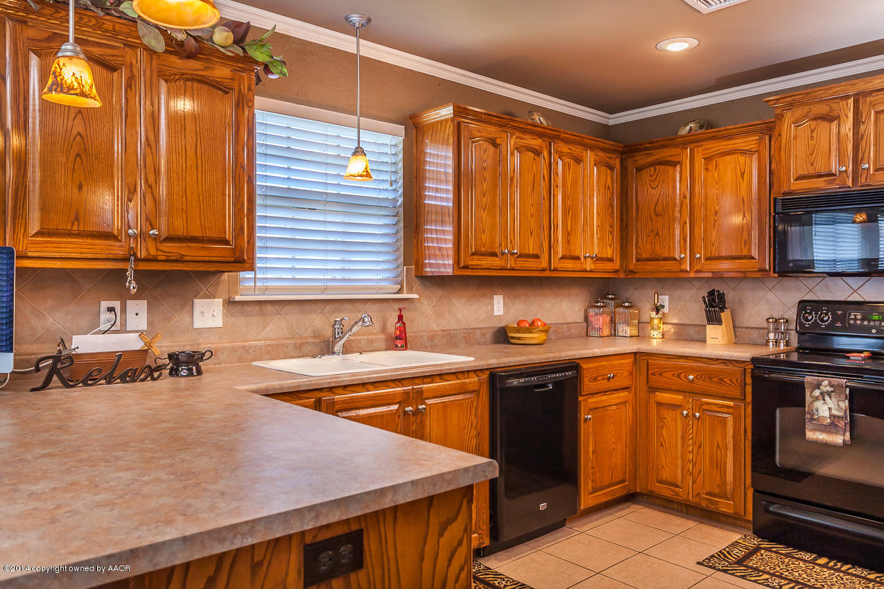 5811 South Rusk Street Amarillo, TX 79118 - Photo 7 of 22 a kitchen with a sink a stove and cabinets