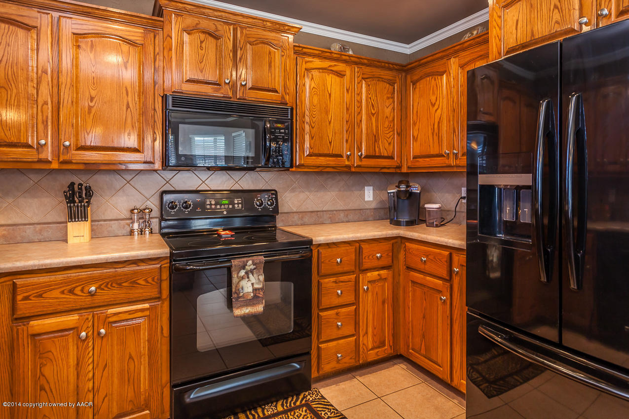 5811 South Rusk Street Amarillo, TX 79118 - Photo 8 of 22 a kitchen with stainless steel appliances granite countertop a refrigerator stove and sink