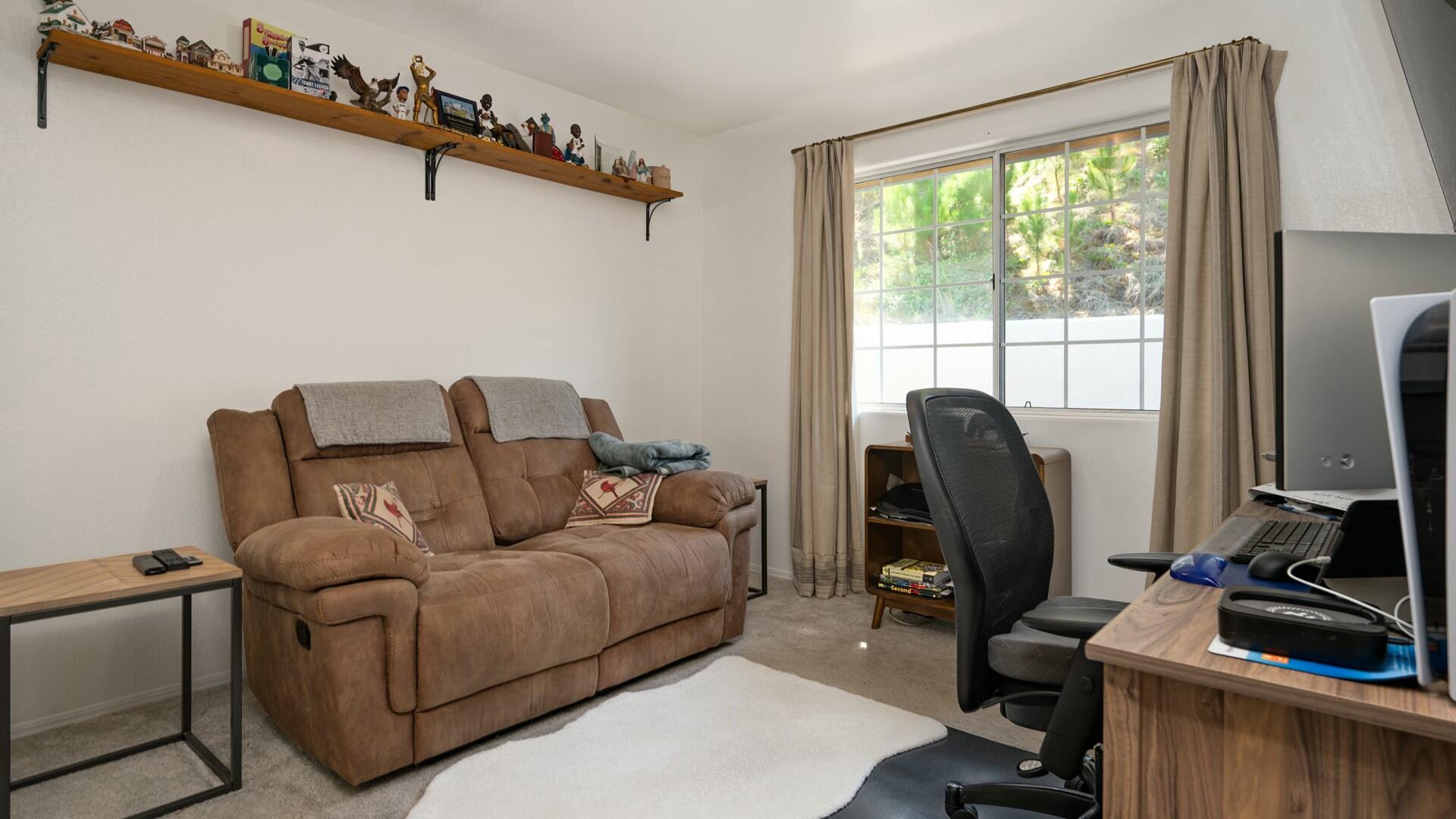 34 Cambridge Drive Lompoc, CA 93436 - Photo 12 of 26 a living room with furniture a flat screen tv and a window