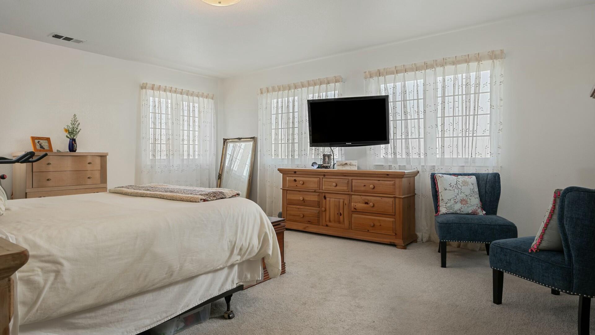 34 Cambridge Drive Lompoc, CA 93436 - Photo 17 of 26 a bedroom with a bed and a flat screen tv