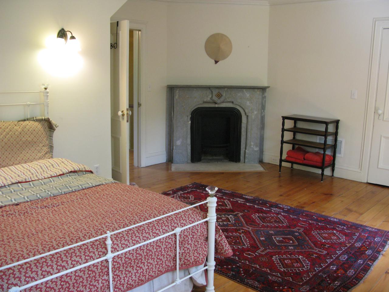 336 Ponus Ridge Road New Canaan, CT 06840 - Photo 15 of 28 a bedroom with a bed and a fireplace