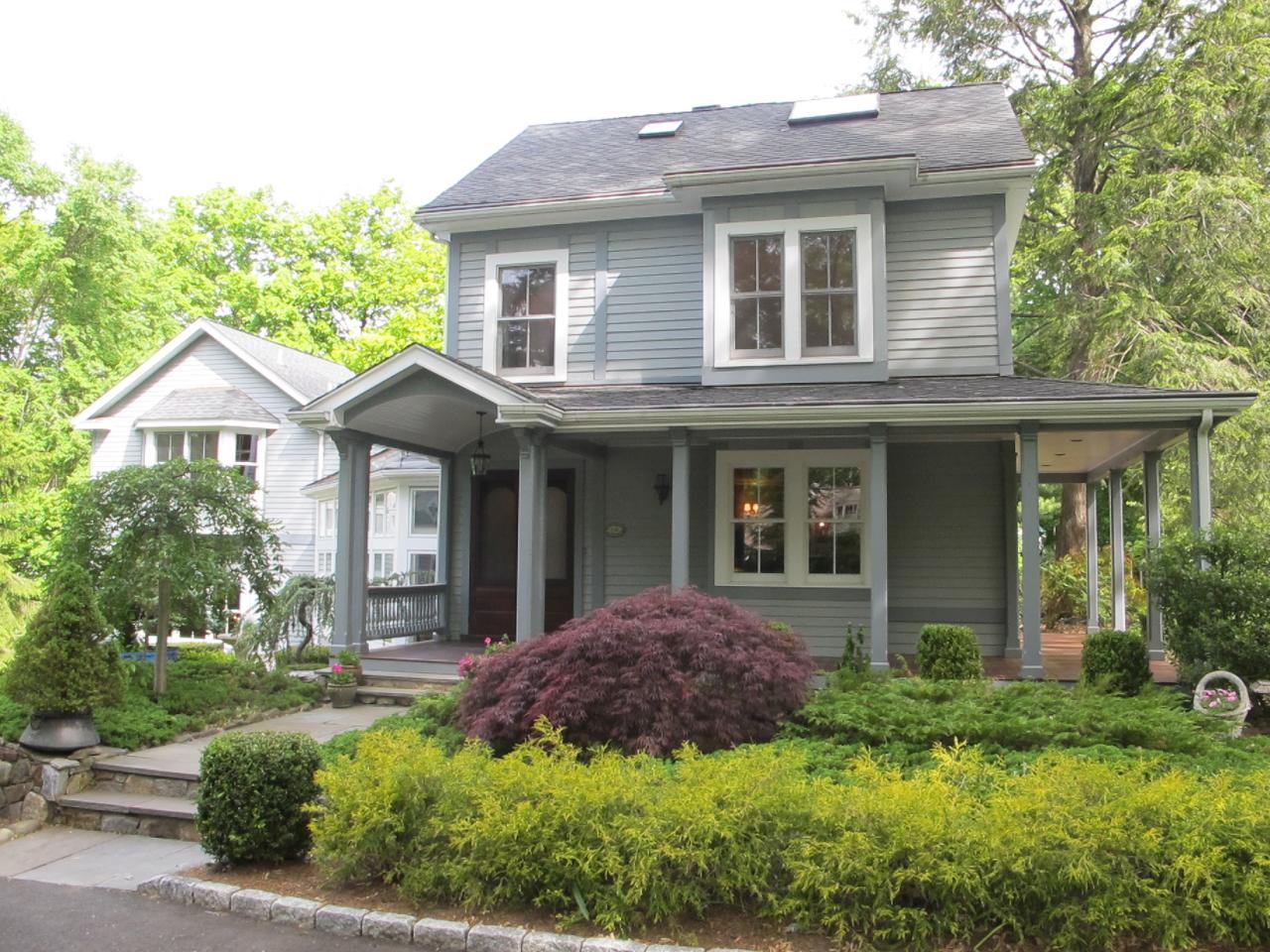 336 Ponus Ridge Road New Canaan, CT 06840 - Photo 2 of 28 a front view of a house with a yard and potted plants