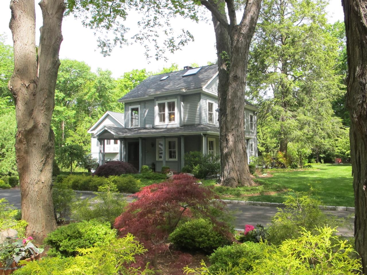 336 Ponus Ridge Road New Canaan, CT 06840 - Photo 24 of 28 a front view of a house with garden