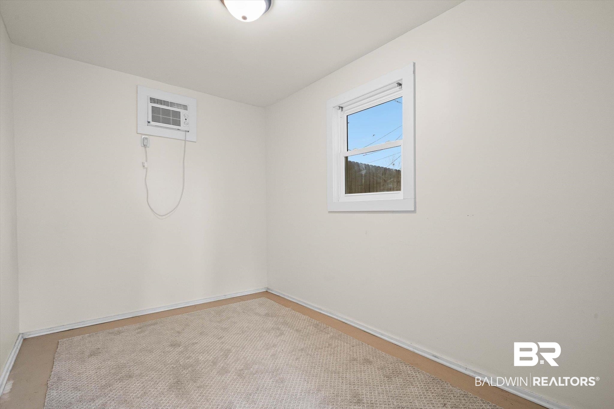 11 York Place Mobile, AL 36608 - Photo 19 of 24 Spare room with baseboards and a wall unit AC