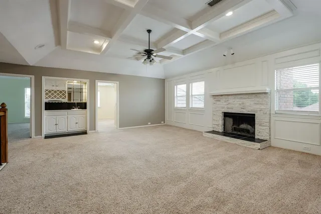 an empty room with a window and a ceiling fan