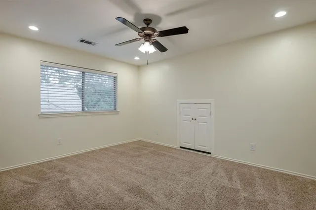 a view of room with a ceiling fan and window
