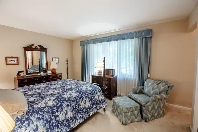 a bedroom with a bed and a dresser in it