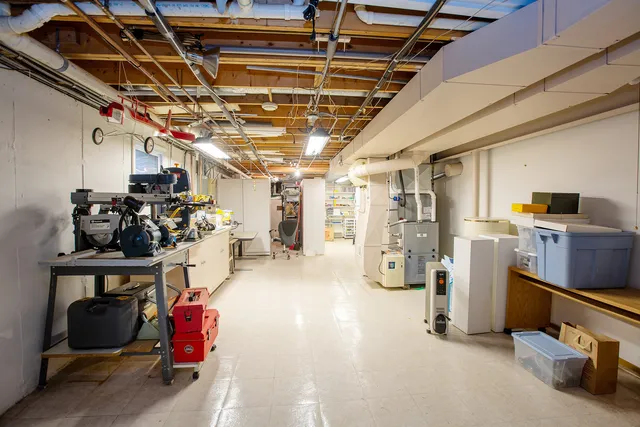 a roof deck with table and chairs and potted plants