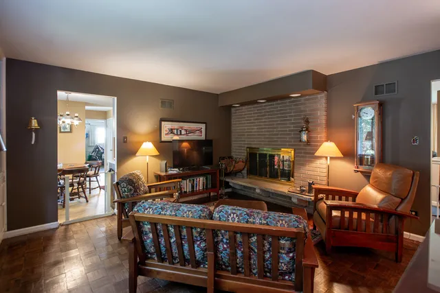 a living room with furniture a lamp and a flat screen tv