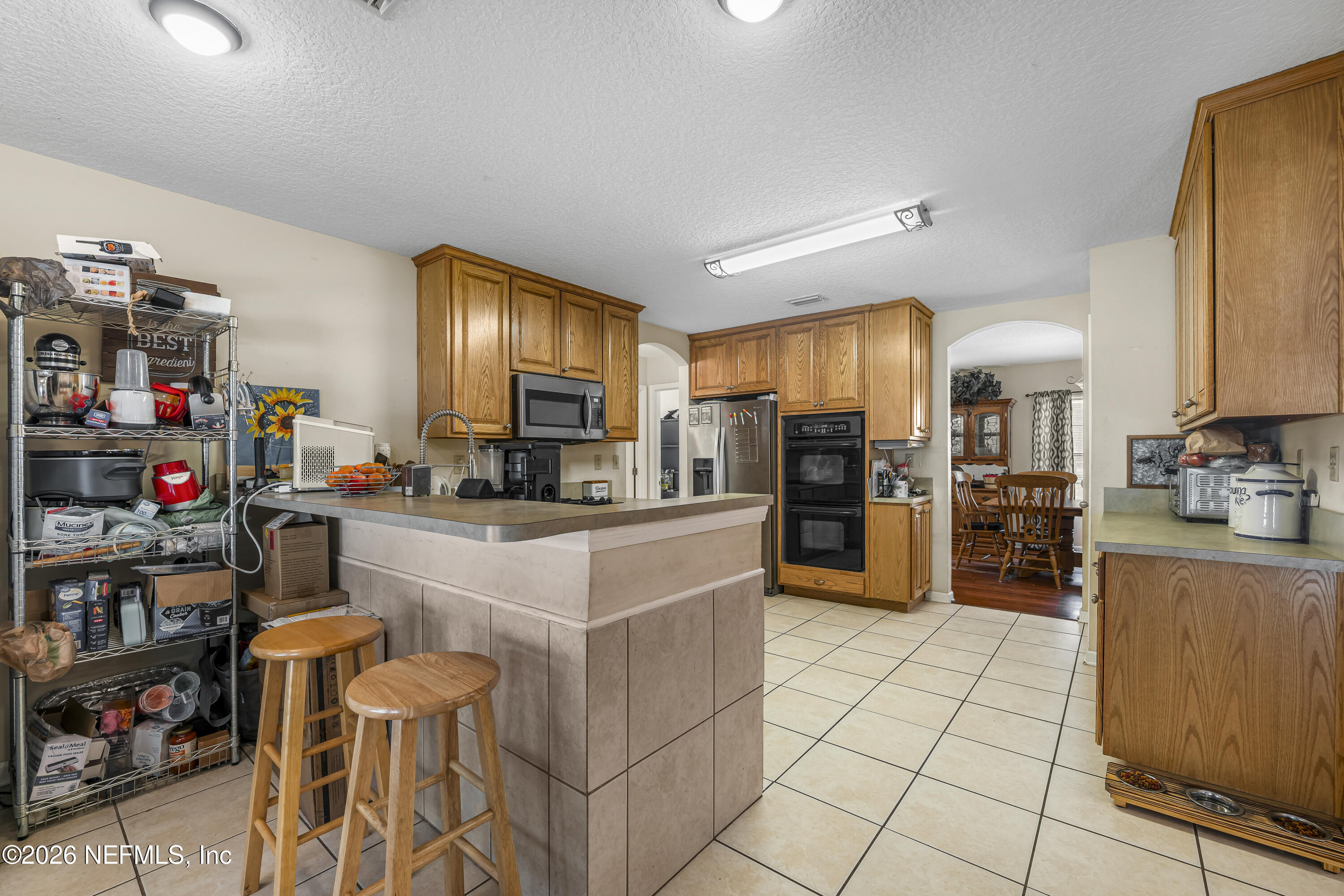 1725 Davidson Farm Road Jacksonville, FL 32218 - Photo 29 of 53 a kitchen with stainless steel appliances a sink and a refrigerator