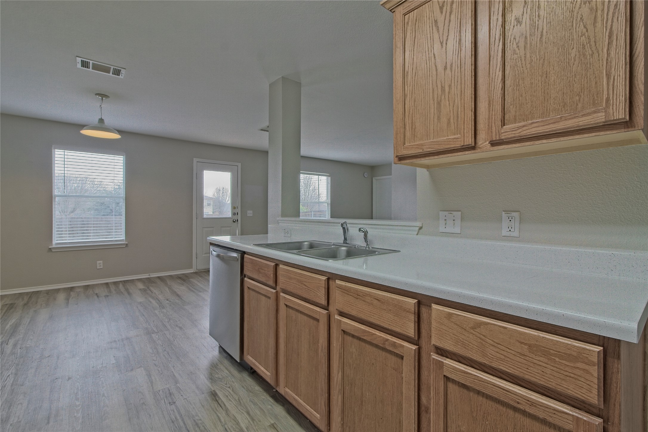 232 Brickyard Lane Jarrell, TX 76537 - Photo 14 of 31 A well-appointed kitchen features a double basin sink and ample cabinetry, opening into a spacious dining area.