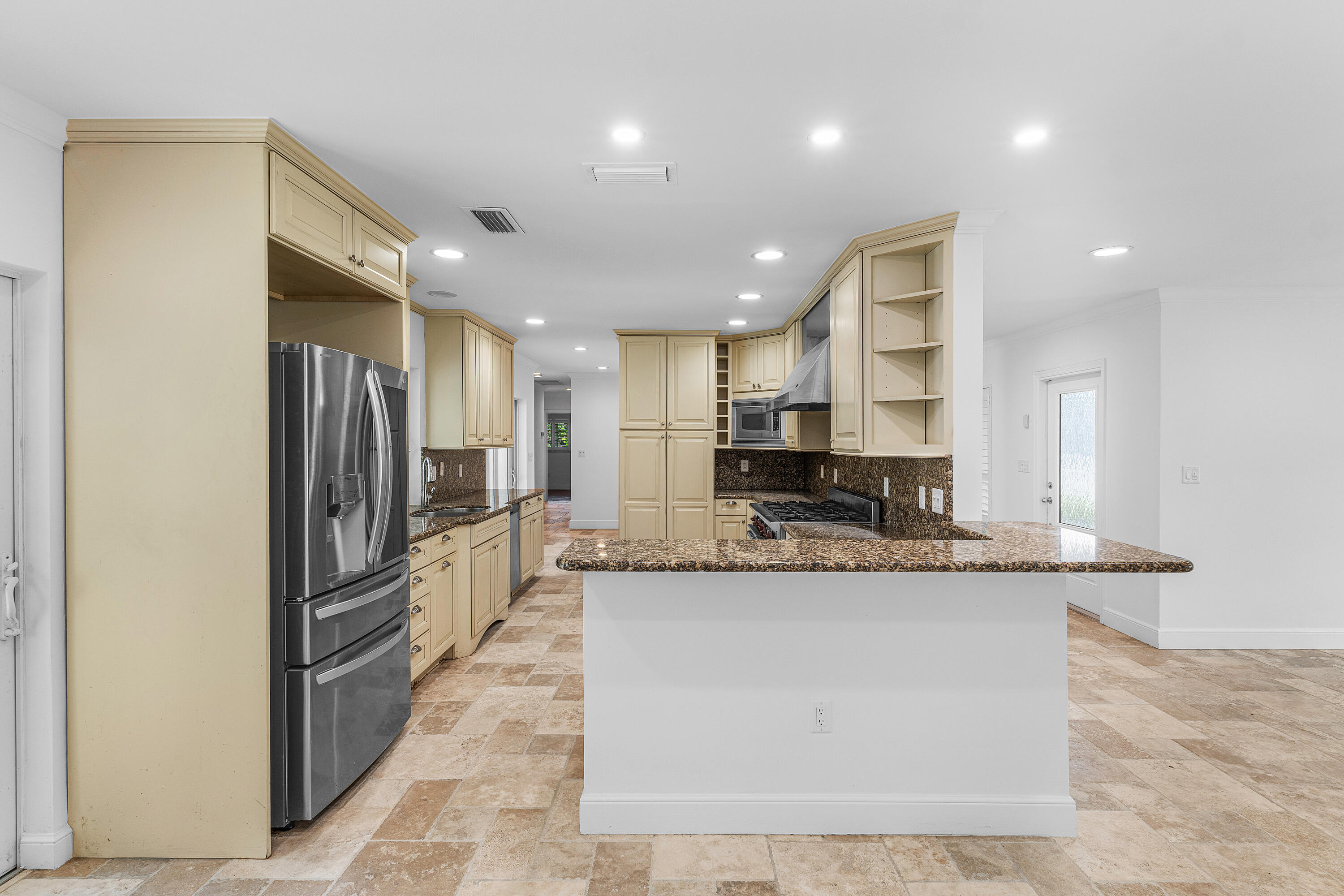 783 Valencia Drive Boca Raton, FL 33432 - Photo 13 of 45 a large kitchen with stainless steel appliances kitchen island a large counter top and a refrigerator